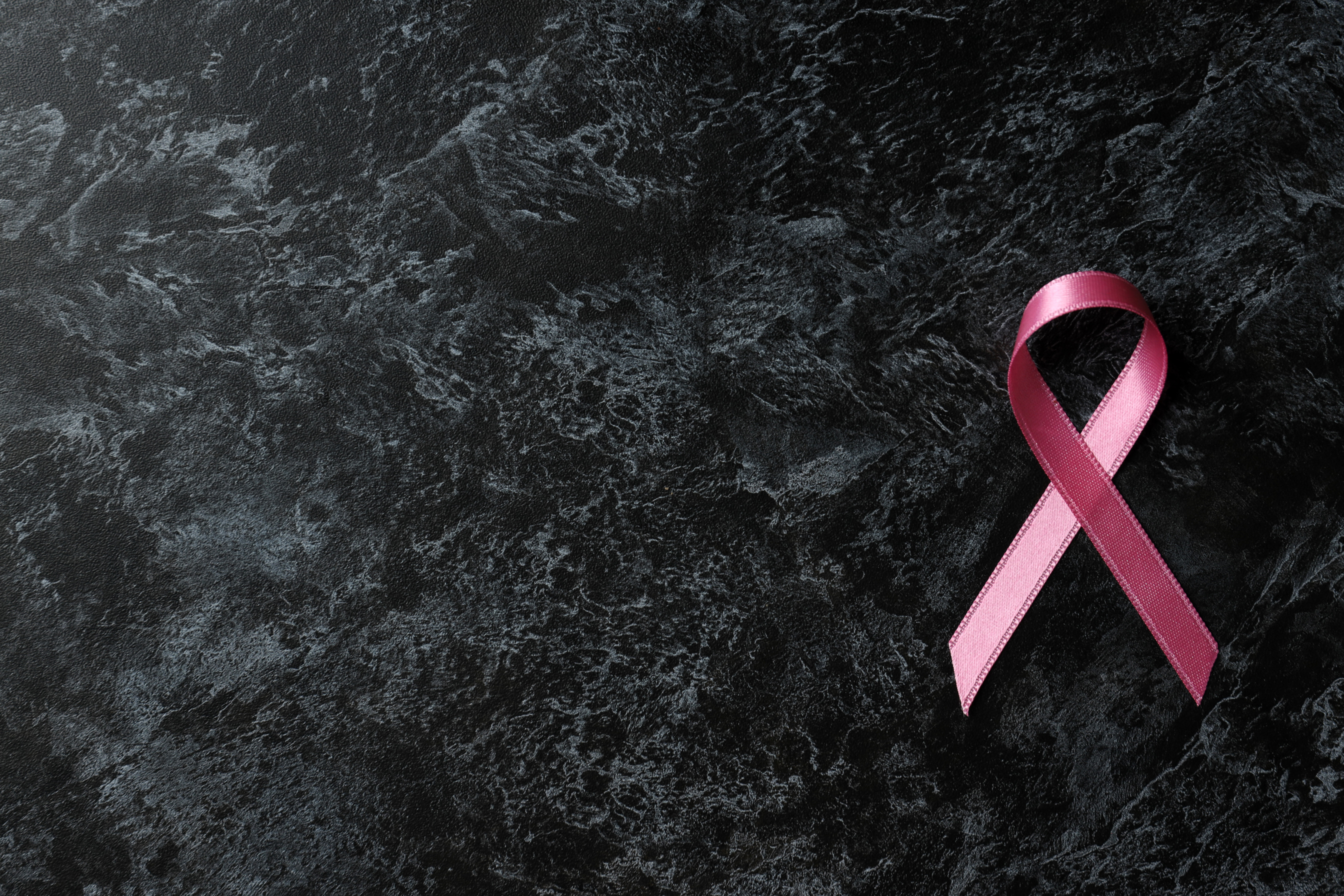 Breast Cancer Awareness Ribbon on Black Smokey Background